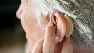 Elderly woman wearing a hearing aid