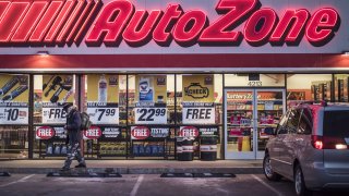 A man walks outside an AutoZone store in Albuquerque, New Mexico.