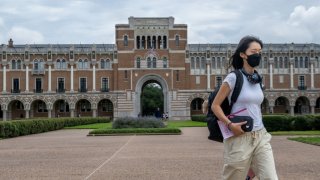 A student walks to class at Rice University in Houston on Aug. 29, 2022.