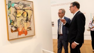 Andy Schulz, The University of Arizona’s Vice President for the Arts (left), and Getty conservation scientist Tom Lerner (right) look at “Woman-Ochre” at the opening of Getty’s “Conserving de Kooning: Theft and Recovery” exhibition in June 2022.