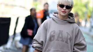 Veronica Guilty is seen wearing a Yeezy Gap Baleciaga hoodie, dress by Reformation, shoes Marine Serre and a bag by Jacquemus to NYFW at Spring Studios on September 10, 2022 in New York City.