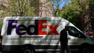 A person walks by a FedEx van in New York City, May 9, 2022.
