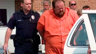Officials escort murder suspect Alan Eugene Miller away from the Pelham City Jail in Ala., on Aug. 5, 1999.
