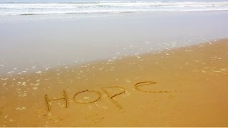 hope written on a beach