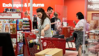 Customers pay bills at the checkout counter at a Target store in Oregon, July 13, 2022.