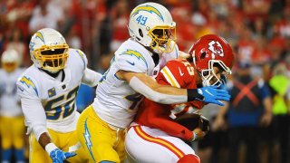Kansas City Chiefs quarterback Patrick Mahomes (15) is sacked by Los Angeles Chargers linebacker Drue Tranquill (49) in the first quarter at Arrowhead Stadium on Thursday, Sept. 15, 2022, in Kansas City, Missouri.