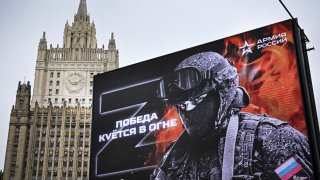 Russian Foreign Ministry building is seen behind a social advertisement billboard showing Z letters – a tactical insignia of Russian troops in Ukraine and reading “Victory is being Forged in Fire” in central Moscow on October 13, 2022.