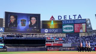 The New York Yankees display a tribute to Bristol, Conn. police Sgt. Dustin Demonte and officer Alex Hamzy before Game 2 of an American League Division baseball series between the New York Yankees and the Cleveland Guardians, Friday, Oct. 14, 2022, in New York. Hamzy and Demonte were killed in the line of duty on Thursday in Bristol, Conn.