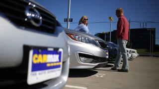 Customers shop for used vehicles at a CarMax dealership in Lexington, Kentucky.