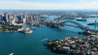 Sydney Harbour in Australia, featuring the Sydney Opera House and Harbour Bridge.