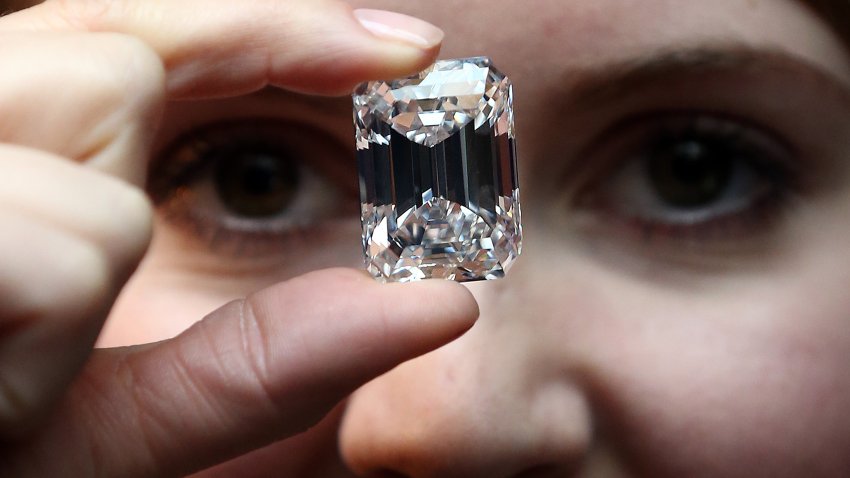 An employee holds a 100-Carat perfect diamond at Sotheby's auction house on February 13, 2015 in London, England.
