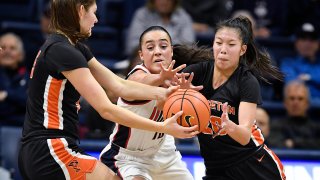 Connecticut's Nika Muhl, center, attempts to intercept a pass between Princeton's Paige Morton, left, and Kaitlyn Chen during the first half of an NCAA college basketball game Thursday, Dec. 8, 2022, in Storrs, Conn.
