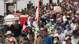 People attend the funeral procession of Clemer Rojas, 23
