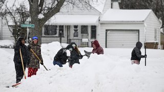 Residents shovel snow in Buffalo, New York, on Dec. 26, 2022.