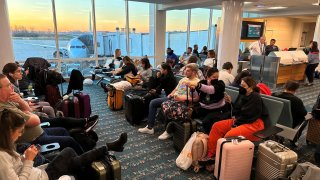 Stranded passengers wait at the Orlando International Airport, as flights were grounded after FAA system outage, in Orlando, Florida, U.S., January 11, 2023 in this picture obtained from social media. 