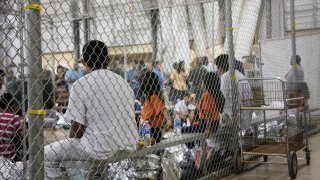 People who've been taken into custody related to cases of illegal entry into the United States sit in one of the cages at a facility in McAllen, Texas, June 17, 2018.