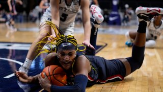 UConn forward Aaliyah Edwards (3) dives for the ball under Butler guard Shay Frederick (5) during the second half of an NCAA college basketball game in Indianapolis, Tuesday, Jan. 3, 2023.