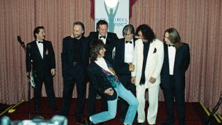 FILE - Jeff Beck plays the air guitar for Jimmy Page