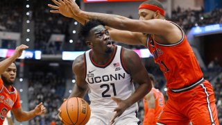 UConn's Adama Sanogo (21) looks to shoot as St. John's Joel Soriano defends in the first half of an NCAA college basketball game, Sunday, Jan. 15, 2023, in Hartford, Conn.
