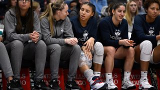 UConn's Paige Bueckers, second from left, talks with teammate Azzi Fudd in the second half of an NCAA college basketball game, Sunday, Jan. 15, 2023, in Hartford, Conn. Fudd left the game in the first half with an injury to her knee and did not return.