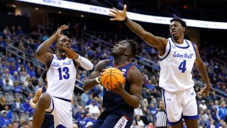 UConn forward Adama Sanogo drives to the basket against Seton Hall forwards KC Ndefo (13) and Tyrese Samuel (4) during the first half of an NCAA college basketball game in Newark, N.J., Wednesday, Jan. 18, 2023.