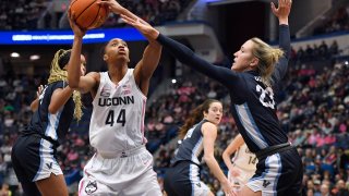 UConn's Aubrey Griffin (44) attempts to shoot as Villanova's Maddie Burke (23) defends in the first half of an NCAA college basketball game, Sunday, Jan. 29, 2023, in Hartford, Conn.