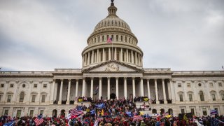 A large group of pro-Trump protesters stand on the East steps of the Capitol Building after storming its grounds on January 6, 2021 in Washington, DC.  (Photo by Jon Cherry/Getty Images)