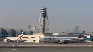 FILE - Passenger aircraft, operated by Emirates Airlines, on the tarmac at Al Maktoum International Airport in Dubai,