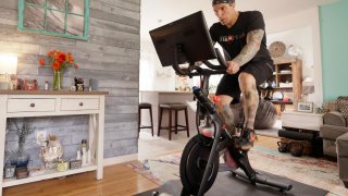 Brody Longo works out on his Peloton exercise bike on April 16, 2021 in Brick, New Jersey.