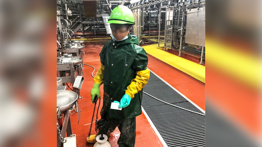 Labor Department investigator photographed a child who worked for Packers Sanitation Services Inc. cleaning a slaughterhouse in Grand Island, Neb. The subject has been blurred by the source.