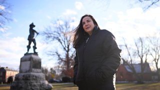 Beth Caruso, author and co-founder of the CT Witch Trial Exoneration Project, which was created to clear the names of the accused, stands on the Palisado Green in Windsor, Conn, in Jan. 24, 2023.