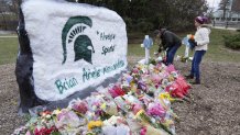 Mourners leave flowers at The Rock on the grounds of Michigan State University in East Lansing, Mich., Wednesday, Feb. 15, 2023. Alexandria Verner, Brian Fraser and Arielle Anderson were killed and several other students remain in critical condition after a gunman opened fire on the campus of Michigan State University Monday night. (AP Photo/Paul Sancya)