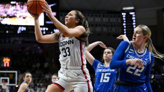 UConn’s Caroline Ducharme (33) shoots as Creighton’s Lauren Jensen (15) and Carly Bachelor (22) defend during the second half of an NCAA college basketball game Wednesday, Feb. 15, 2023, in Storrs, Conn.