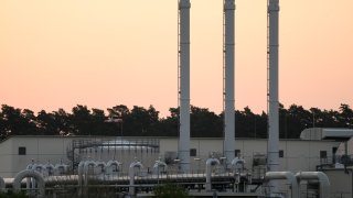 The sun rises behind the landfall facility of the Nord Stream 1 Baltic Sea pipeline and the transfer station of the OPAL gas pipeline, the Baltic Sea Pipeline Link, in Lubmin, Germany, July 21, 2022.