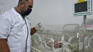 A newborn baby, who was found still tied by her umbilical cord to her mother then pulled alive from the rubble of a home in northern Syria, receives medical care from doctor Hani Maaruf, at a clinic in Afrin, Feb. 7, 2023. The infant is the sole survivor of her immediate family, the rest of whom were all killed when a 7.8-magnitude quake that struck Syria and Turkey flattened the family home in the rebel-held town of Jindaris, the baby's cousin, Khalil al-Suwadi, said.