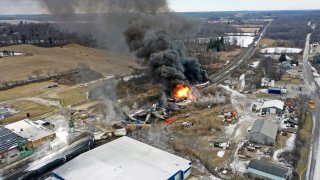 This photo taken with a drone shows portions of a Norfolk and Southern freight train that derailed Friday night in East Palestine, Ohio are still on fire at mid-day, Feb. 4, 2023.