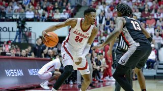 Brandon Miller dribbles against a South Carolina defender.