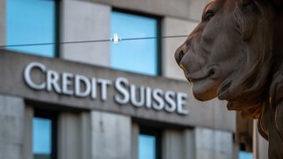 A sign of Credit Suisse bank is seen on a branch building in Geneva, on March 15, 2023.