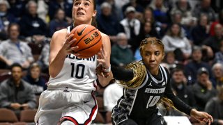 Georgetown’s Kennedy Fauntleroy (10) fouls UConn’s Nika Muhl (10) during the first half of an NCAA college basketball game in the quarterfinals of the Big East Conference tournament at Mohegan Sun Arena, Saturday, March 4, 2023, in Uncasville, Conn.
