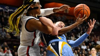 Connecticut's Aaliyah Edwards (3) and Marquette's Chloe Marotta (52) fight for a rebound during the first half of an NCAA college basketball game in the semifinals of the Big East Conference tournament at Mohegan Sun Arena, Sunday, March 5, 2023, in Uncasville, Conn.