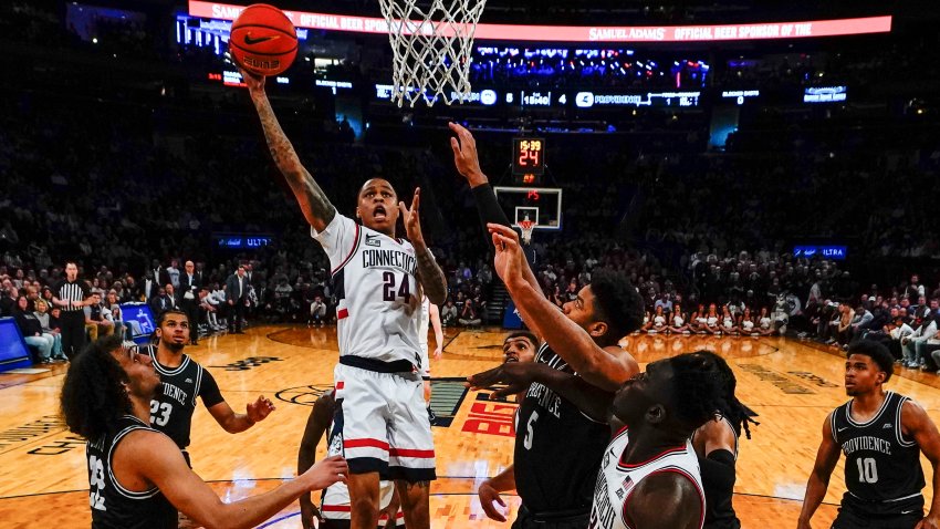 Connecticut’s Jordan Hawkins (24) shoots over Providence’s Devin Carter (22) and Ed Croswell (5) during the first half of an NCAA college basketball game in the quarterfinals of the Big East Conference Tournament Thursday, March 9, 2023, in New York.