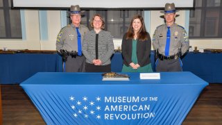 Connecticut State Librarian, Deborah Schander, and museum Administrator, Jennifer DiCola Matos, attended the Repatriation Ceremony in Philadelphia and enlisted the help of Connecticut State Police officers, Sgt. Dickie Murchinson and TFC Kevin Cook, to bring the object home.
