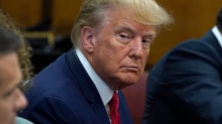 Former U.S. President Donald Trump sits with his attorneys inside the courtroom during his arraignment at the Manhattan Criminal Court April 4, 2023 in New York City.