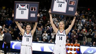 UConn's Lou Lopez-Senechal (11) and UConn's Dorka Juhasz (14) hold up their jerseys during senior night ceremonies before an NCAA college basketball game against Xavier, Monday, Feb. 27, 2023, in Storrs, Conn.