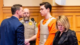 Willard Miller speaks with his attorney Nathan Olson, left, next to attorney Christine Branstad during a hearing, March 29, 2023, in Fairfield, Iowa, for a hearing related to the murder charge he faces in the 2021 death of Fairfield, Iowa, Spanish teacher Nohema Graber.