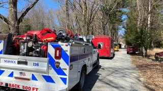 Crews work to put out a brush fire in Baltic.