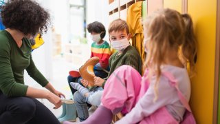Children in cloakroom getting ready.