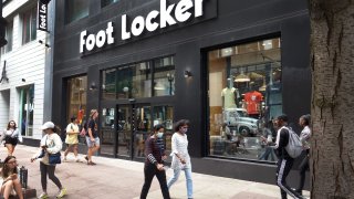 A sign hangs above the entrance of a Foot Locker store on August 02, 2021 in Chicago, Illinois.