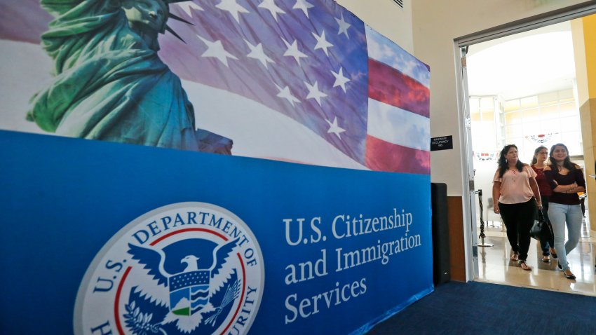 People arrive before the start of a naturalization ceremony at the U.S. Citizenship and Immigration Services Miami Field Office, Friday, Aug. 17, 2018, in Miami. One hundred forty-two citizenship candidates from 33 countries took the Oath of Allegiance. (AP Photo/Wilfredo Lee)