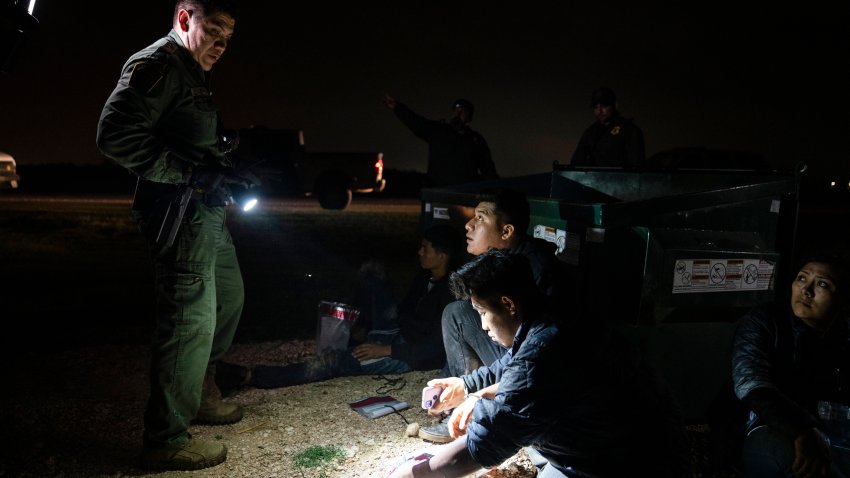 Migrants that were trying to evade U.S. Border Patrol agents, wait to be processed in Granjeno, Texas, early Thursday, May 4, 2023. In almost two weeks the Rio Grande Valley Sector has been the busiest sector averaging nearly 2,000 apprehensions a day. (AP Photo/Veronica G. Cardenas)